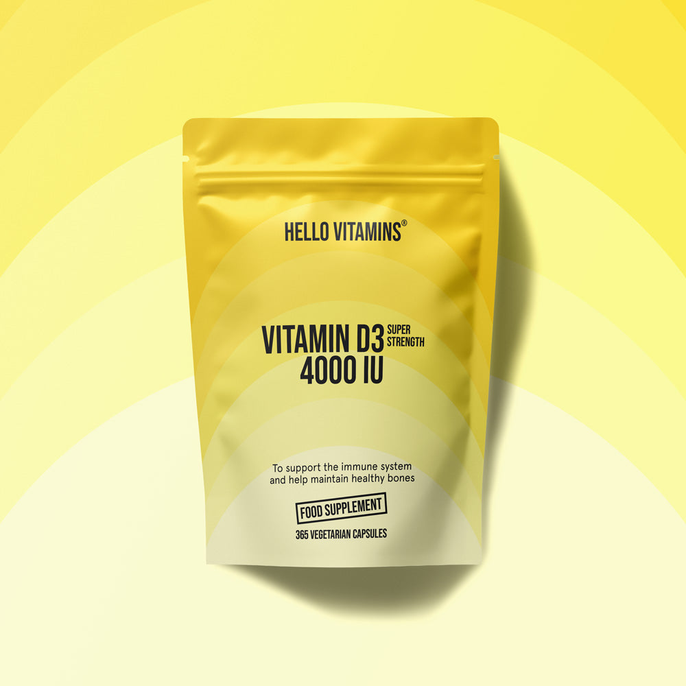 Yellow supplement package labeled 'Hello Vitamins' on a yellow background